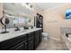 This primary bathroom features a double sink vanity with black cabinets and a glass enclosed shower at 2262 Galloway Sw Ln, Concord, NC 28025