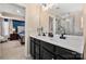 This primary bathroom features a double sink vanity with black cabinets, and glass shower at 2262 Galloway Sw Ln, Concord, NC 28025
