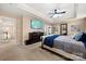 Relaxing main bedroom featuring neutral carpet, large TV, and a stylish ceiling fan at 2262 Galloway Sw Ln, Concord, NC 28025