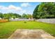 Spacious, level backyard featuring lush green grass, a wood fence, and a small patio at 2290 Kestrel Dr, Rock Hill, SC 29732