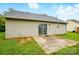 Backyard with vinyl siding, a small patio, lush green grass, and a sliding glass door at 2290 Kestrel Dr, Rock Hill, SC 29732