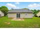 Level backyard with green grass, a small patio, and views of the home's rear exterior at 2290 Kestrel Dr, Rock Hill, SC 29732