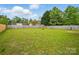A large backyard with lush green grass and a tall wooden fence is perfect for outdoor activities at 2290 Kestrel Dr, Rock Hill, SC 29732