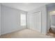 Bright bedroom with light paint, plush carpeting, and bi-fold closet doors for ample storage at 2290 Kestrel Dr, Rock Hill, SC 29732
