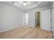 Large bright bedroom with tray ceiling, carpet, and access to bathroom at 2290 Kestrel Dr, Rock Hill, SC 29732