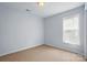 A spacious bedroom with neutral paint, carpet flooring, and a large window for natural light at 2290 Kestrel Dr, Rock Hill, SC 29732