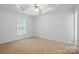 Neutral bedroom features tray ceiling, neutral carpet and large window with light at 2290 Kestrel Dr, Rock Hill, SC 29732