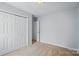 Bedroom featuring light paint, plush carpeting, and bi-fold closet doors for ample storage at 2290 Kestrel Dr, Rock Hill, SC 29732