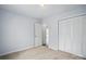 Bright bedroom with light paint, plush carpeting, and bi-fold closet doors for ample storage at 2290 Kestrel Dr, Rock Hill, SC 29732