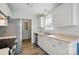 Bright kitchen with stainless steel appliances, white cabinets, and wood-look flooring at 2290 Kestrel Dr, Rock Hill, SC 29732