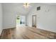 Open-concept living room showcasing wood floors, neutral paint, and view into the dining area at 2290 Kestrel Dr, Rock Hill, SC 29732