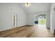 Bright living room transitioning to dining space featuring wood floors and views of a fenced backyard at 2290 Kestrel Dr, Rock Hill, SC 29732