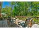 Inviting deck area featuring chairs and table, overlooking a serene yard with mature trees and lush greenery at 2815 Burnt Mill Rd, Charlotte, NC 28210