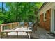 A cozy outdoor setting featuring a wooden deck with comfortable seating amidst a lush, green backdrop at 2815 Burnt Mill Rd, Charlotte, NC 28210