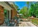 Charming deck area with seating and outdoor furniture, set against a backdrop of mature trees and a well-maintained yard at 2815 Burnt Mill Rd, Charlotte, NC 28210