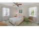 Bedroom featuring a ceiling fan, two windows and neutral decor at 2815 Burnt Mill Rd, Charlotte, NC 28210