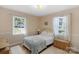Bedroom with two windows, hardwood floors, bed and neutral decor at 2815 Burnt Mill Rd, Charlotte, NC 28210