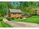 Lovely brick home with black shutters surrounded by lush greenery and a winding driveway at 2815 Burnt Mill Rd, Charlotte, NC 28210