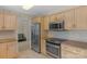 Charming kitchen with stainless steel appliances, warm-toned cabinetry, and neutral countertops with easy access to other rooms at 2815 Burnt Mill Rd, Charlotte, NC 28210