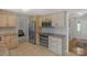 Bright kitchen featuring stainless steel appliances, warm-toned cabinetry, neutral countertops, and easy access to the front entrance at 2815 Burnt Mill Rd, Charlotte, NC 28210