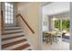 View of the home's staircase and a glimpse into the kitchen and dining area at 2815 Burnt Mill Rd, Charlotte, NC 28210