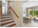 View of the home's staircase and a glimpse into the kitchen and dining area at 2815 Burnt Mill Rd, Charlotte, NC 28210