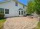 View of patio area with brick pavers and a built-in fire pit with white siding at 3002 Fair Meadows Dr, Monroe, NC 28110