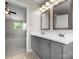 Bathroom featuring double sink vanity, tiled flooring, two mirrors, and access to the main bedroom at 3002 Fair Meadows Dr, Monroe, NC 28110
