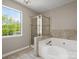 Bathroom featuring tiled flooring, a shower, a tub, and a window at 3002 Fair Meadows Dr, Monroe, NC 28110