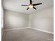 Spacious bedroom with neutral carpet and a modern ceiling fan for added comfort at 3002 Fair Meadows Dr, Monroe, NC 28110