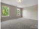 Expansive bedroom with plush carpeting, neutral walls, and two windows offering lots of natural light at 3002 Fair Meadows Dr, Monroe, NC 28110