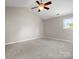 Spacious bedroom with a ceiling fan, vaulted ceiling, neutral walls, and carpet flooring at 3002 Fair Meadows Dr, Monroe, NC 28110