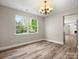 Bright dining room featuring wood floors, neutral walls, and views of the living room at 3002 Fair Meadows Dr, Monroe, NC 28110