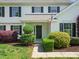 Close-up of the home's entrance, showcasing a black front door and well-maintained landscaping at 3002 Fair Meadows Dr, Monroe, NC 28110