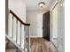 Hallway view with hardwood floors and stairs, leading to the upper level of the home at 3002 Fair Meadows Dr, Monroe, NC 28110