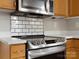 The Kitchen is complete with stainless steel appliances, sleek white backsplash, and modern finishes at 3002 Fair Meadows Dr, Monroe, NC 28110