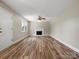 Bright living room with hardwood floors, a fireplace, and a ceiling fan at 3002 Fair Meadows Dr, Monroe, NC 28110