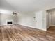 Spacious living room with a fireplace, ceiling fan, and wood-look flooring at 3002 Fair Meadows Dr, Monroe, NC 28110