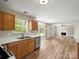 The kitchen area leads to a living space complete with a fireplace at 3002 Fair Meadows Dr, Monroe, NC 28110