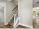 Carpeted staircase with a white railing and hardwood floors in the adjacent hallway at 3002 Fair Meadows Dr, Monroe, NC 28110