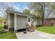 The backyard includes a door, stairs and a concrete patio at 303 S Iredell Ave, Spencer, NC 28159