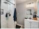 Modern bathroom featuring a tiled shower and vanity with a black faucet and hardware at 303 S Iredell Ave, Spencer, NC 28159