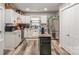Well-lit kitchen with white cabinets, stainless steel appliances, and a functional island with breakfast bar at 303 S Iredell Ave, Spencer, NC 28159
