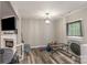 Spacious living room featuring laminate flooring, a faux fireplace, and ample natural light at 303 S Iredell Ave, Spencer, NC 28159
