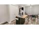 Open living space with wood floors, an island with breakfast bar, and seamless transition to kitchen area at 303 S Iredell Ave, Spencer, NC 28159