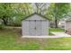 Backyard view of the property showcasing a neutral colored shed with barn doors at 303 S Iredell Ave, Spencer, NC 28159