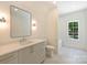 Bright bathroom with modern vanity, stylish mirror, and a window above the bathtub at 3473 Willow Oak Rd, Charlotte, NC 28209