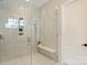 Modern walk-in shower featuring glass surround, bench seating, and rainfall showerhead at 3473 Willow Oak Rd, Charlotte, NC 28209