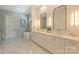 Elegant bathroom featuring double vanities, a standalone tub, and modern fixtures at 3473 Willow Oak Rd, Charlotte, NC 28209