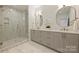 Elegant bathroom with double sinks, gold fixtures, and glass-enclosed shower at 3473 Willow Oak Rd, Charlotte, NC 28209